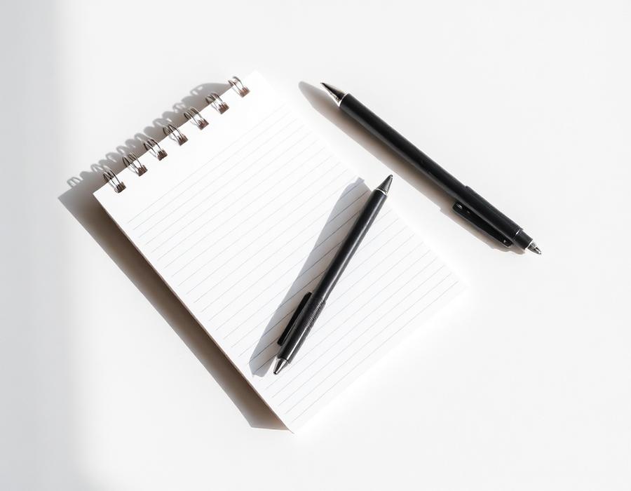Lined notepad with two ballpoint pens